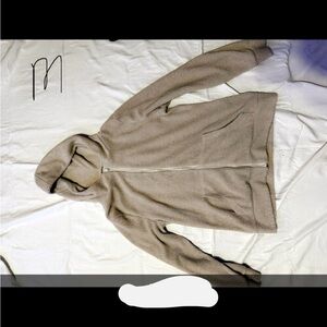A medium tan fuzzy zip up jacket